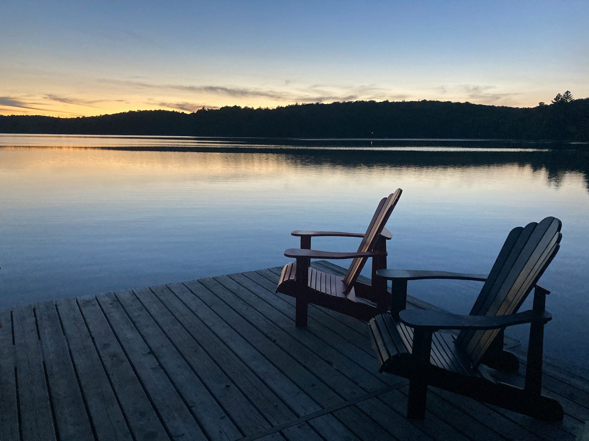 Muskoka chairs at sunset